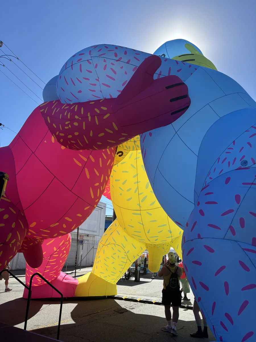 Giant inflatable bears hugging at a street festival